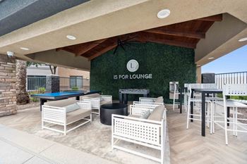 A patio with a pool table and chairs is labeled  at The Laurel Apartments, Chandler, AZ